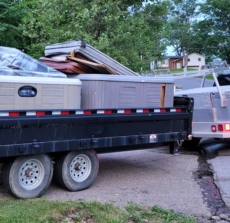 Old spas and decking hauled away on a trailer
